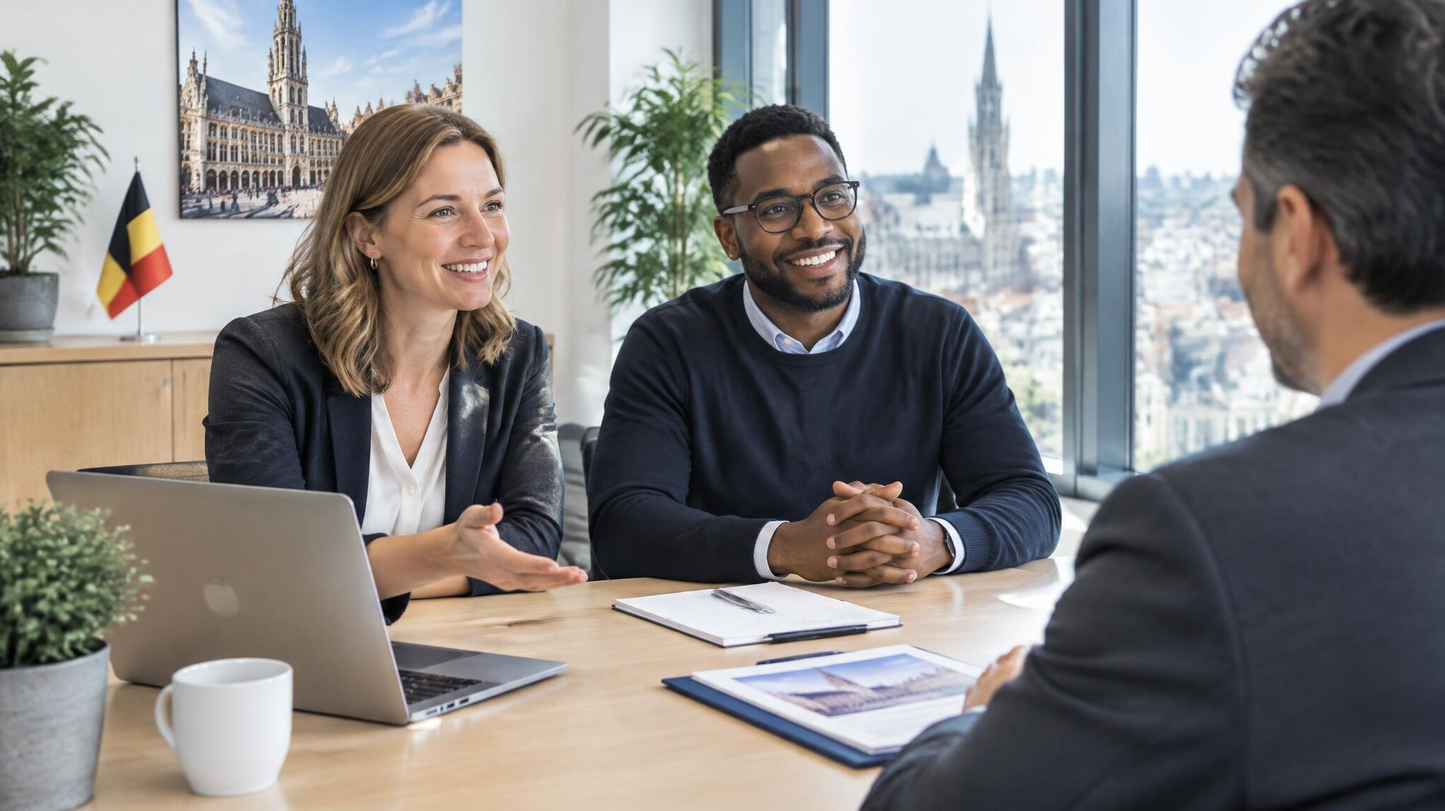 Professionals welcoming a new client in a bright office meeting room